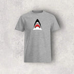 Gray t-shirt with a shark graphic on a textured gray background