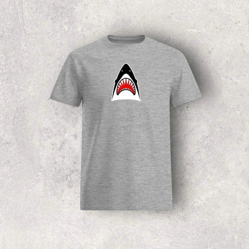 Gray t-shirt with a shark graphic on a textured gray background