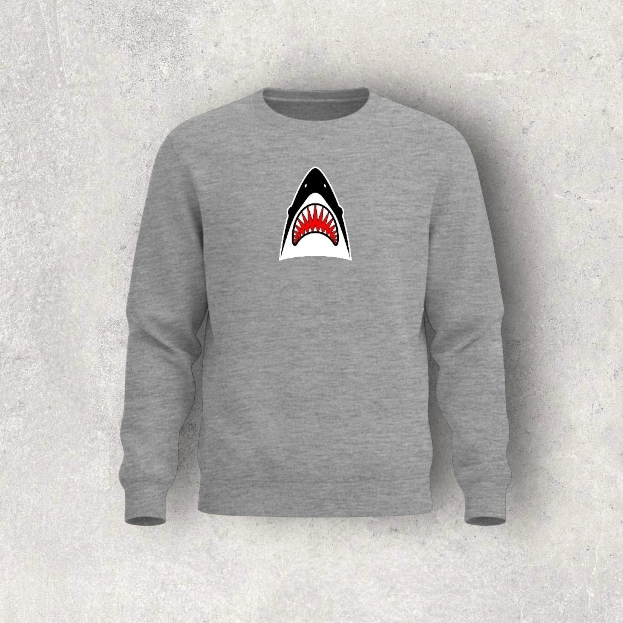 Gray sweatshirt with a shark graphic on a textured gray background