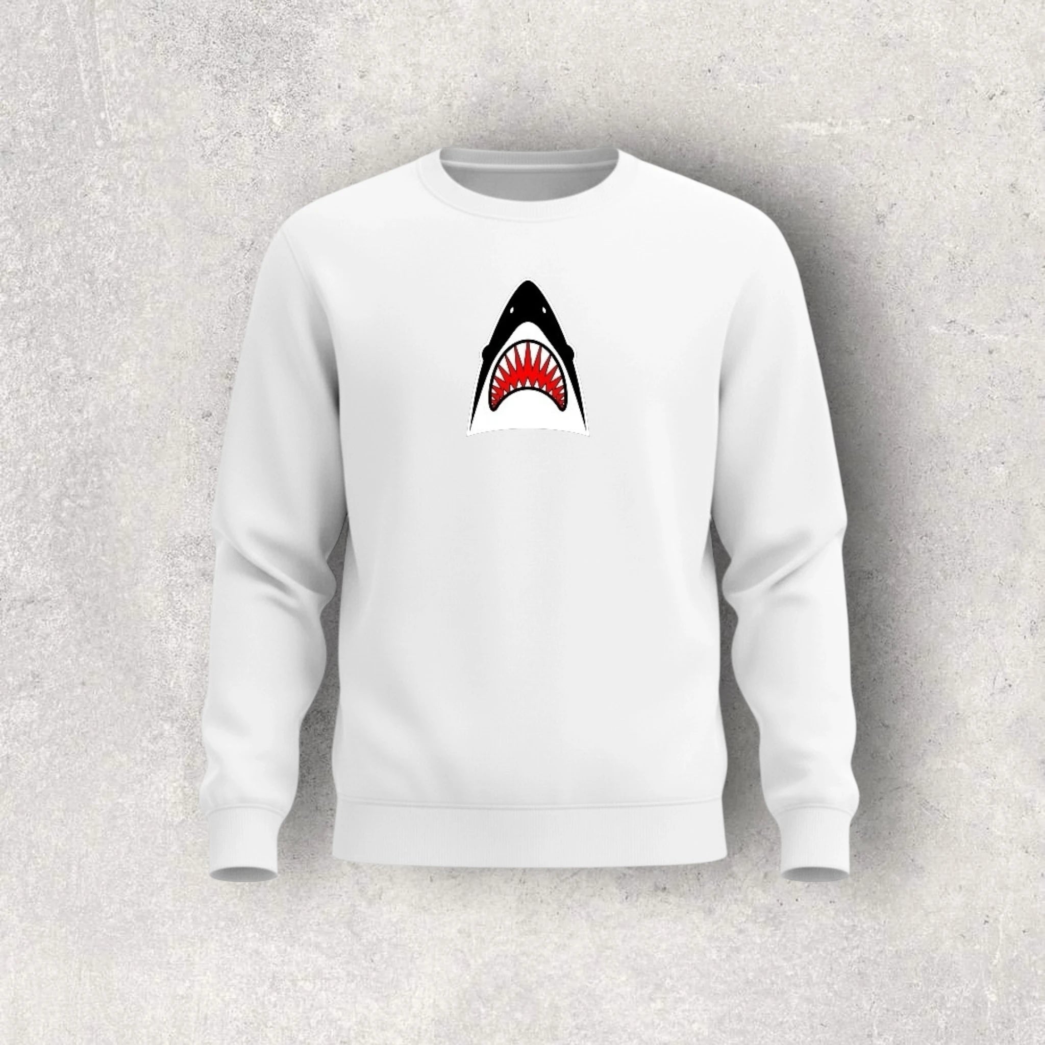 White sweatshirt with a shark graphic on a gray background