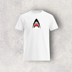 White t-shirt with a shark graphic on a gray textured background