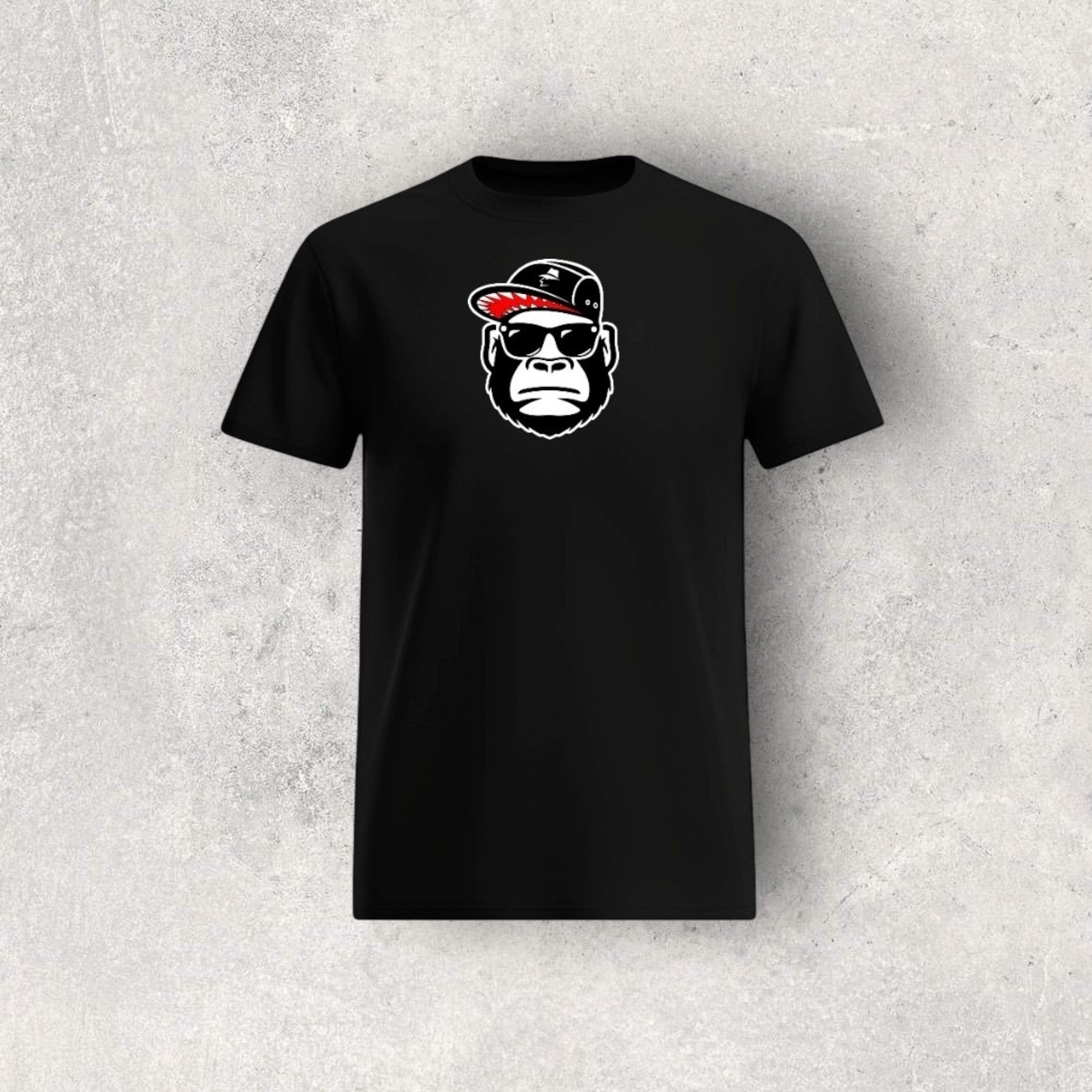 Black t-shirt with a graphic of a monkey wearing a cap and sunglasses on a textured gray background