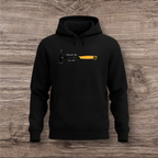 Black hoodie with a hammer graphic and text on a wooden surface