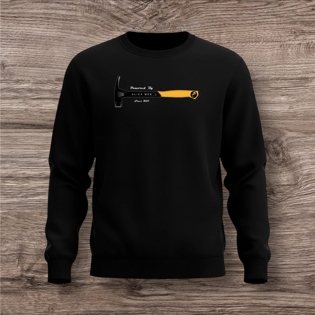 Black sweatshirt with a hammer graphic and text on a wooden surface