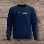 Navy blue sweatshirt with a hammer graphic and text on a wooden surface