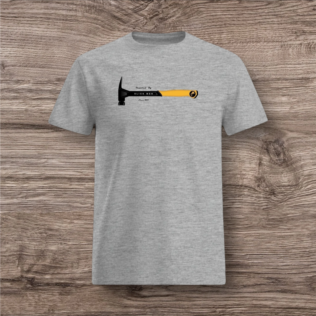 Gray t-shirt with a hammer graphic and text on a wooden surface