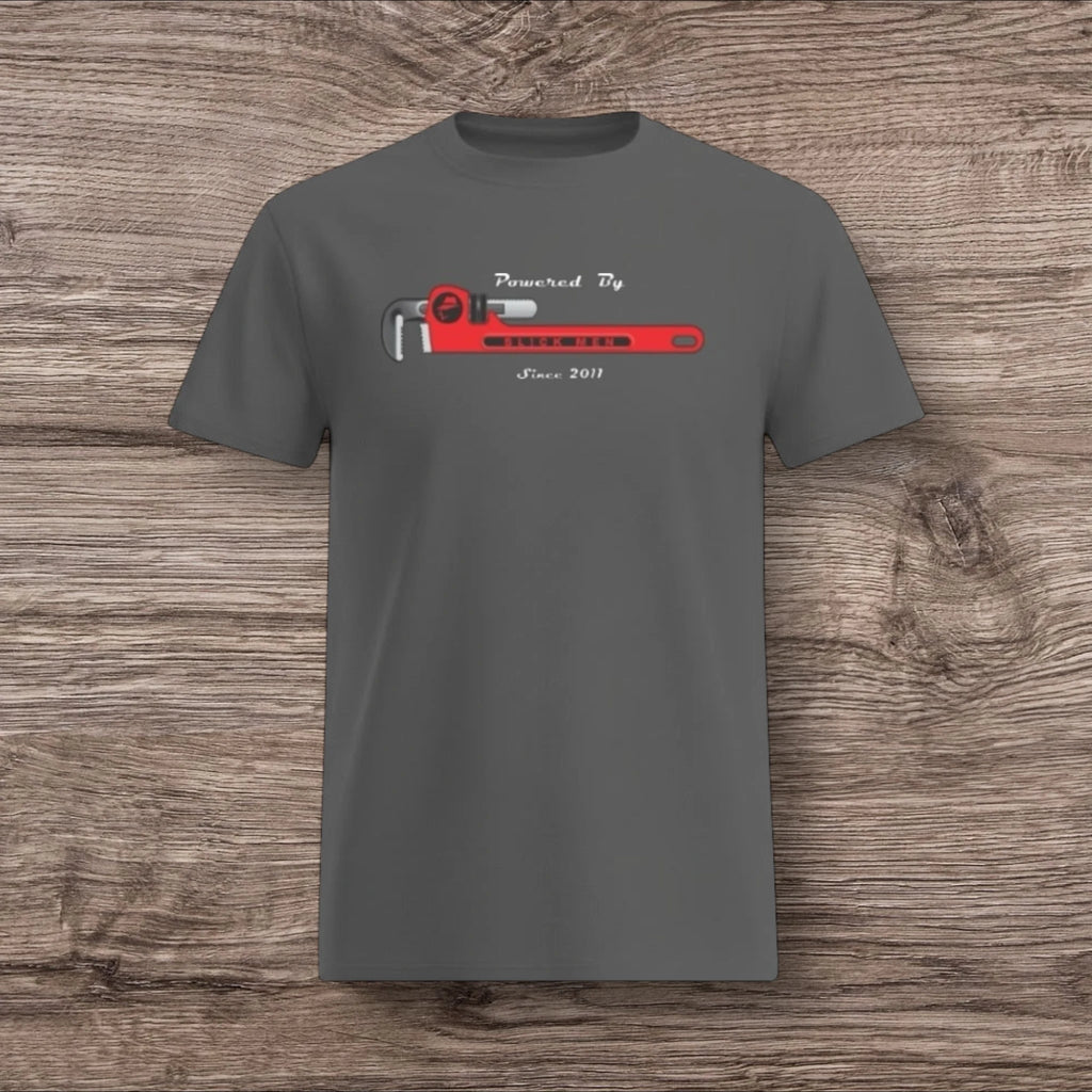 Gray t-shirt with a plumber wrench design on a wooden surface