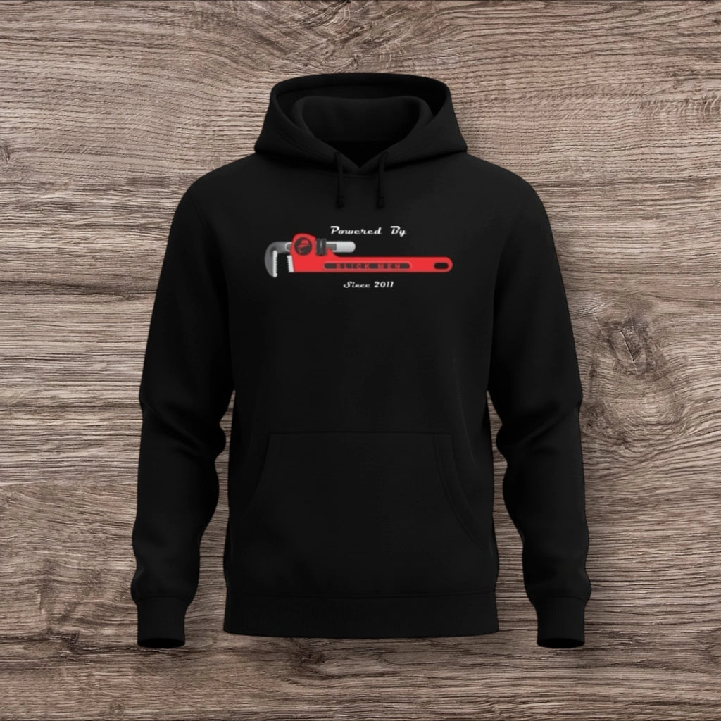 Black hoodie with a plumber wrench graphic on a wooden surface