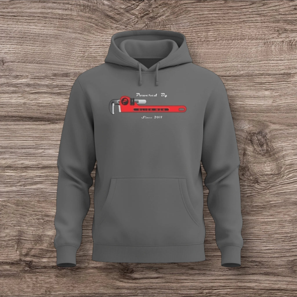 Gray hoodie with a plumber wrench graphic on a wooden surface