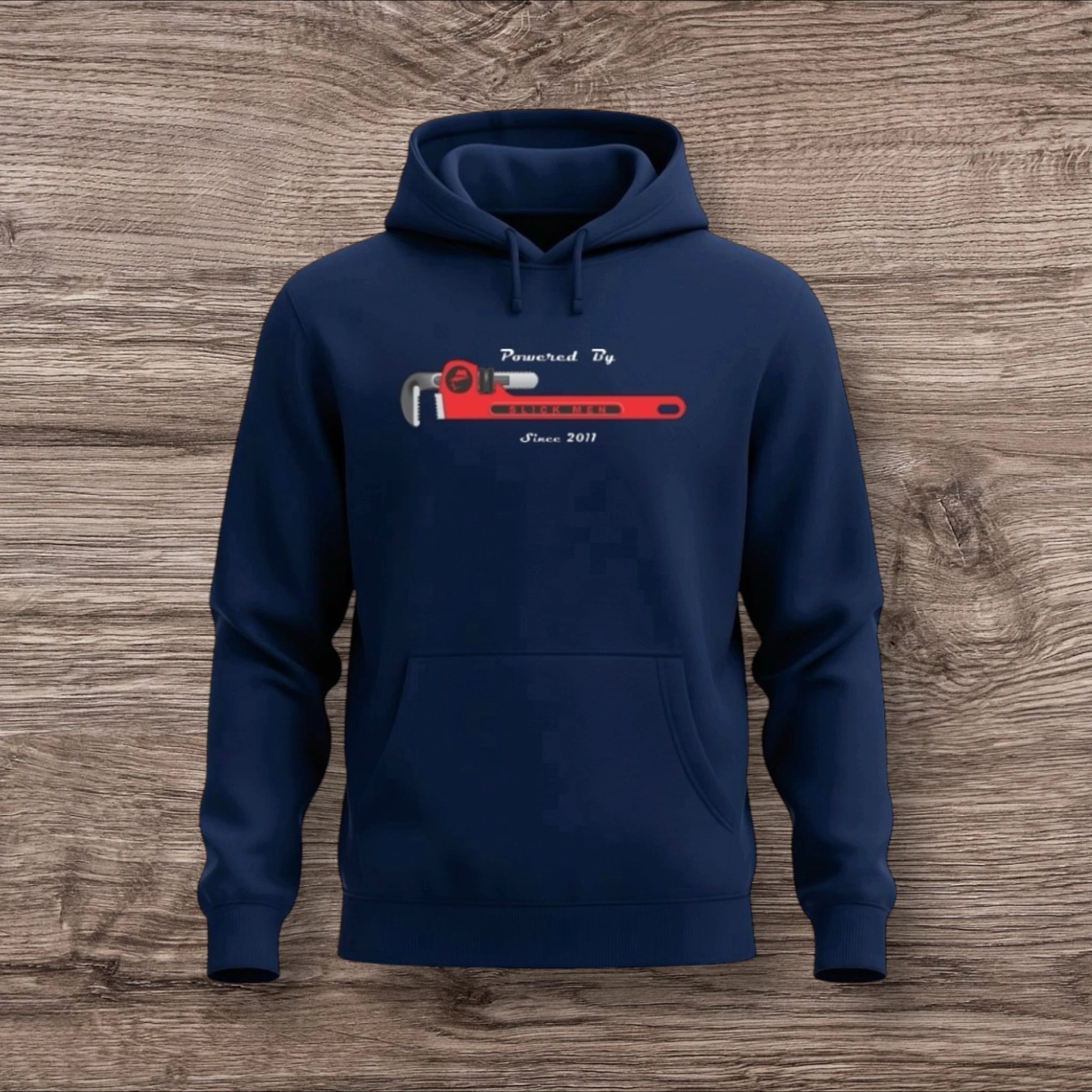 Navy blue hoodie with a plumber wrench graphic on a wooden surface