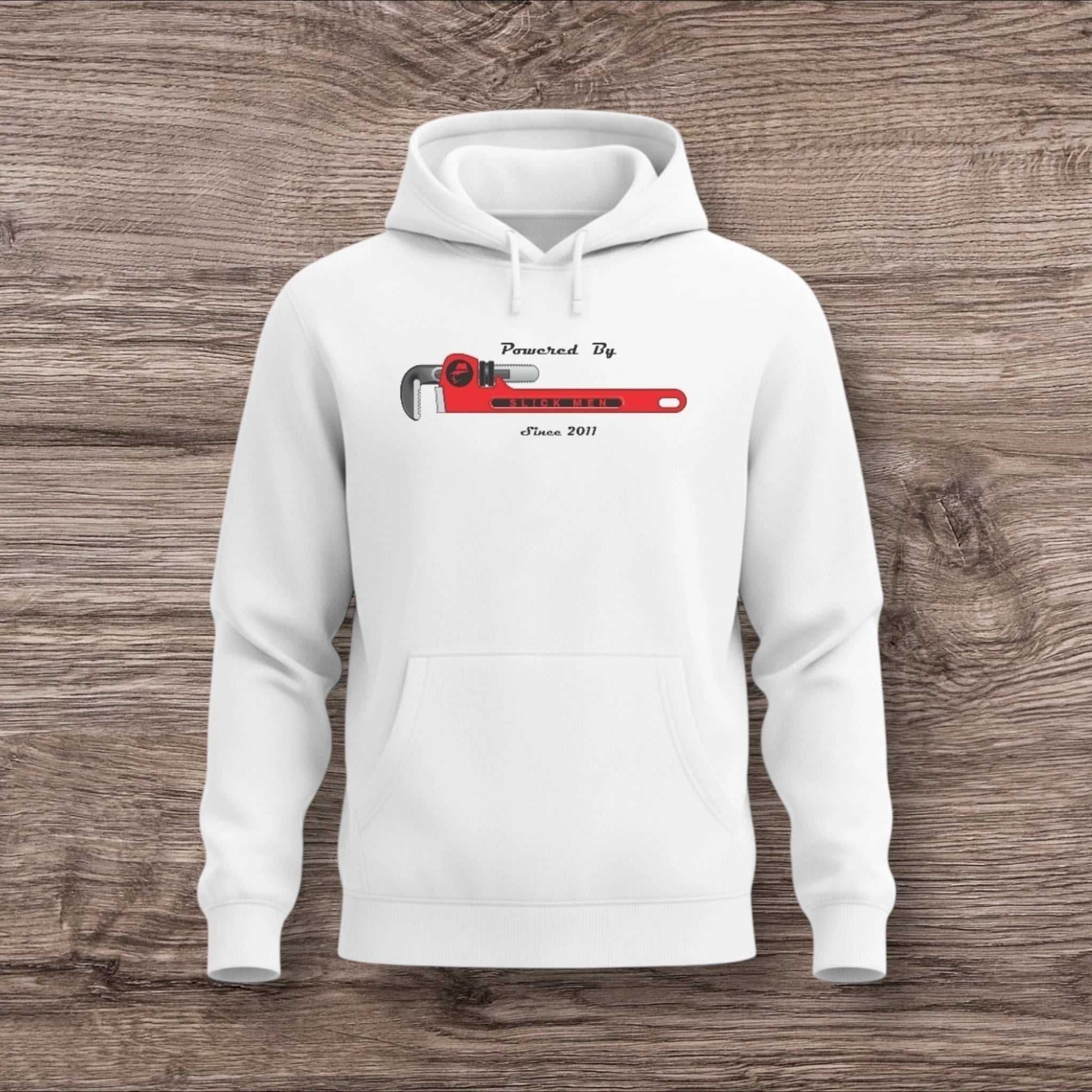 White hoodie with a plumber wrench design on a wooden surface