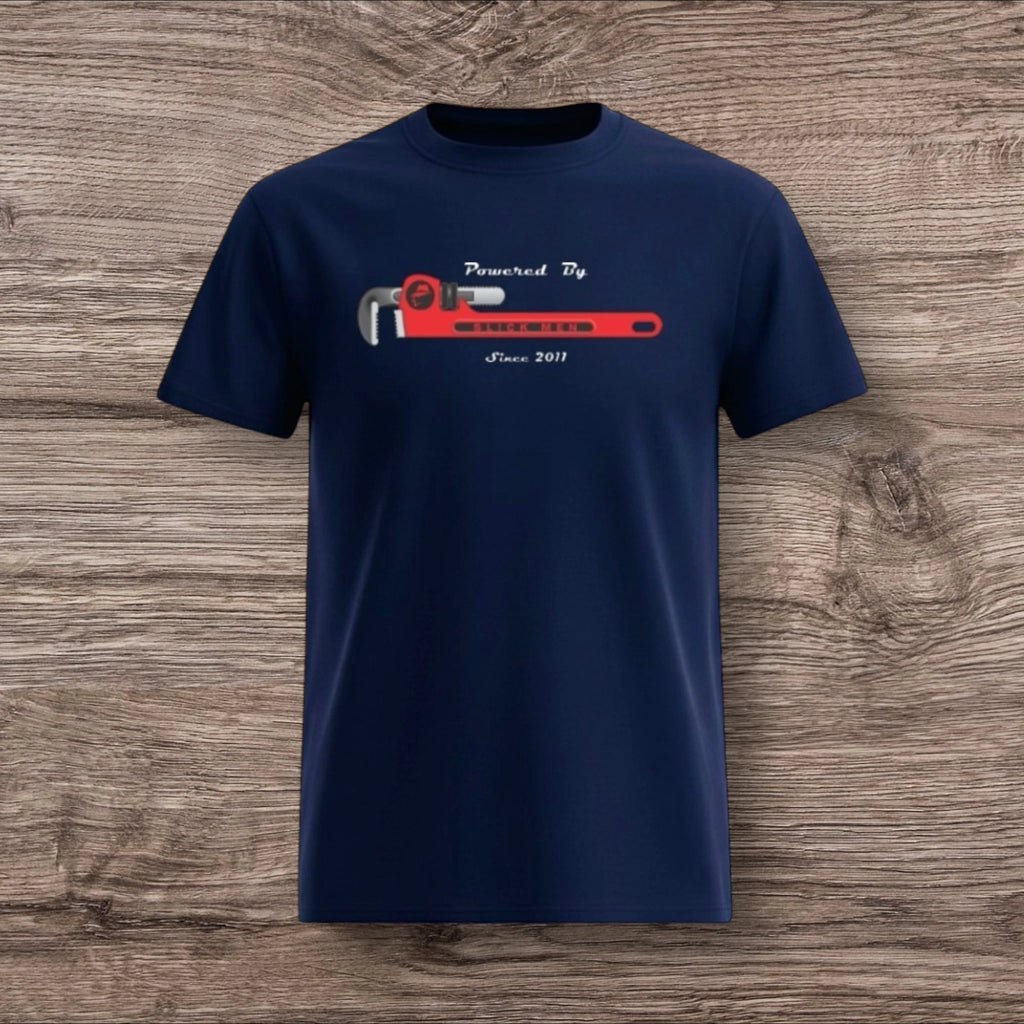 Navy blue t-shirt with a plumber wrench design on a wooden surface