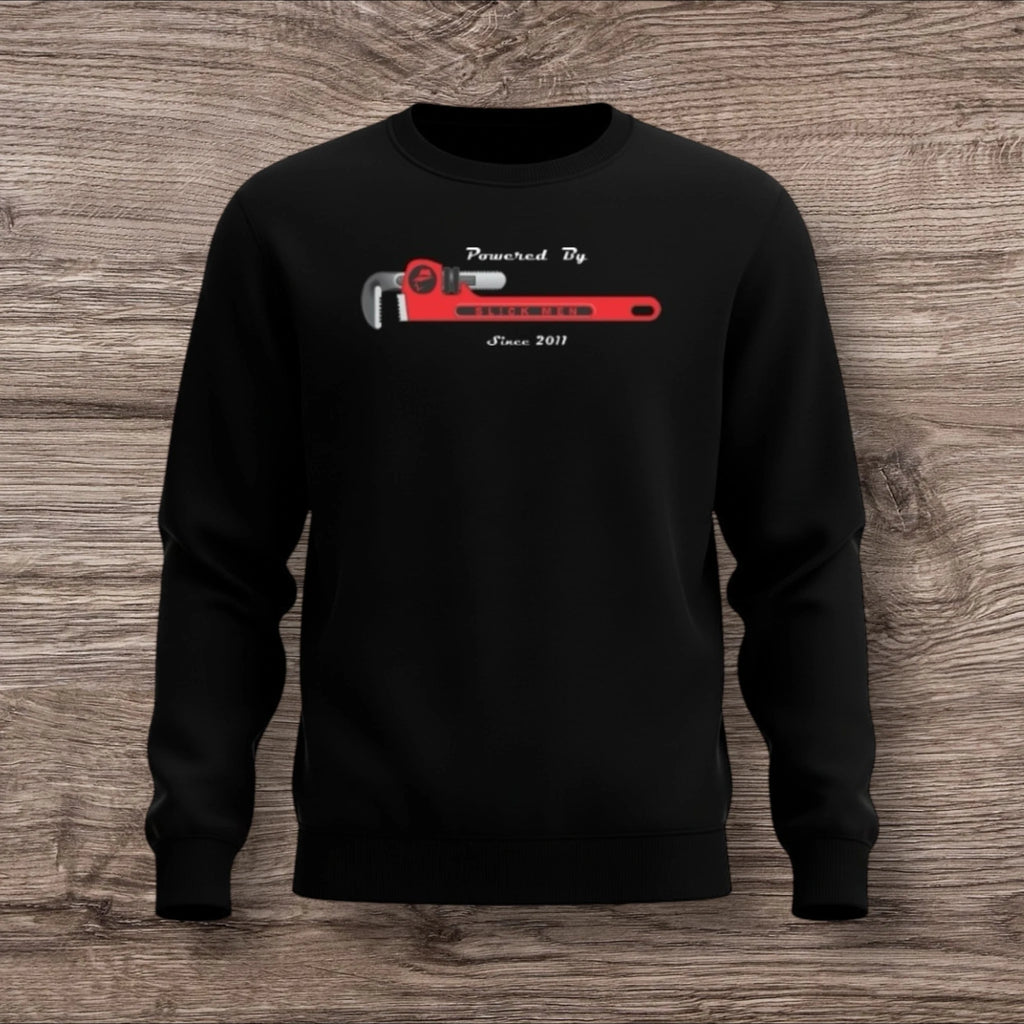 Black sweatshirt with a plumber wrench on a wooden surface