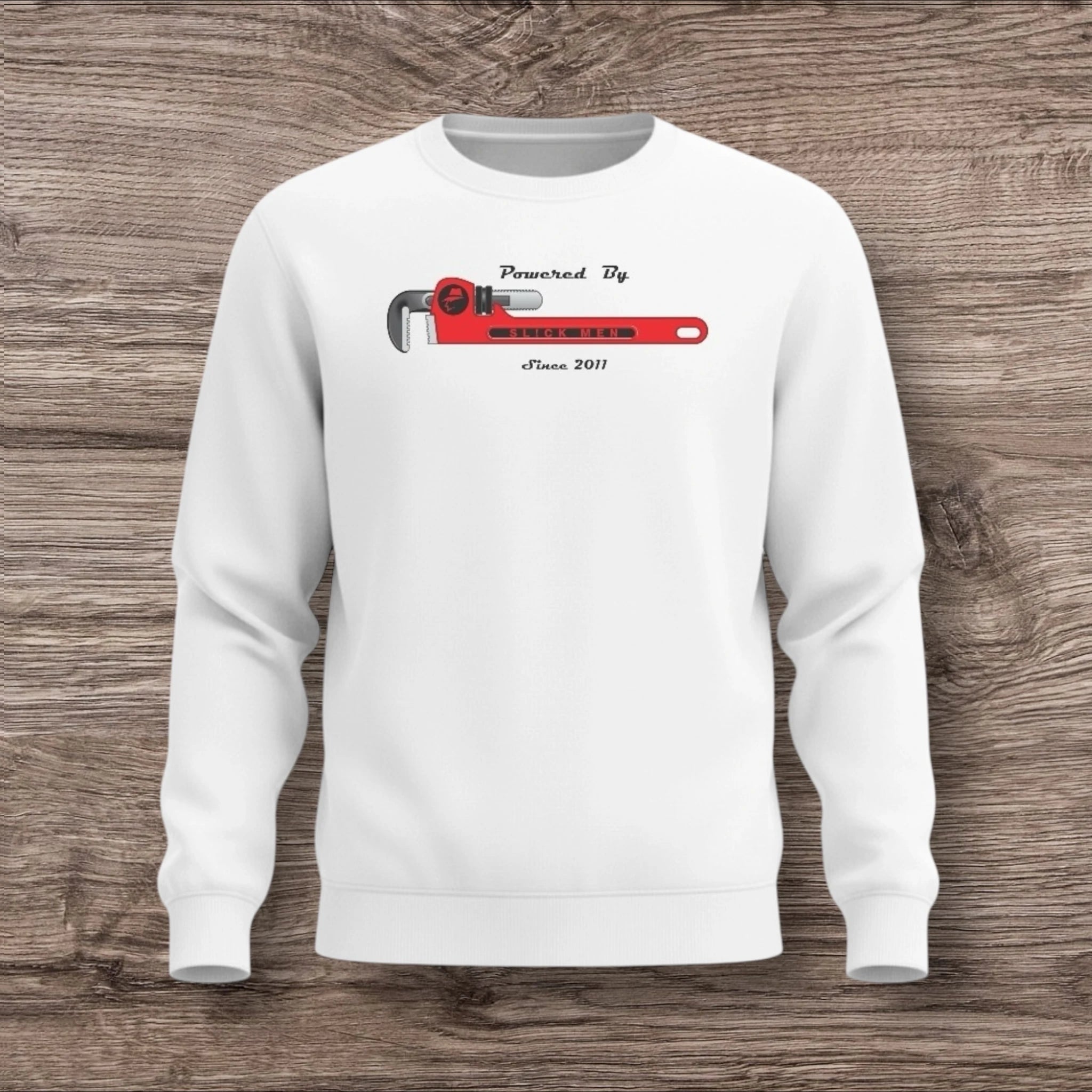 White sweatshirt with a plumber wrench on a wooden background