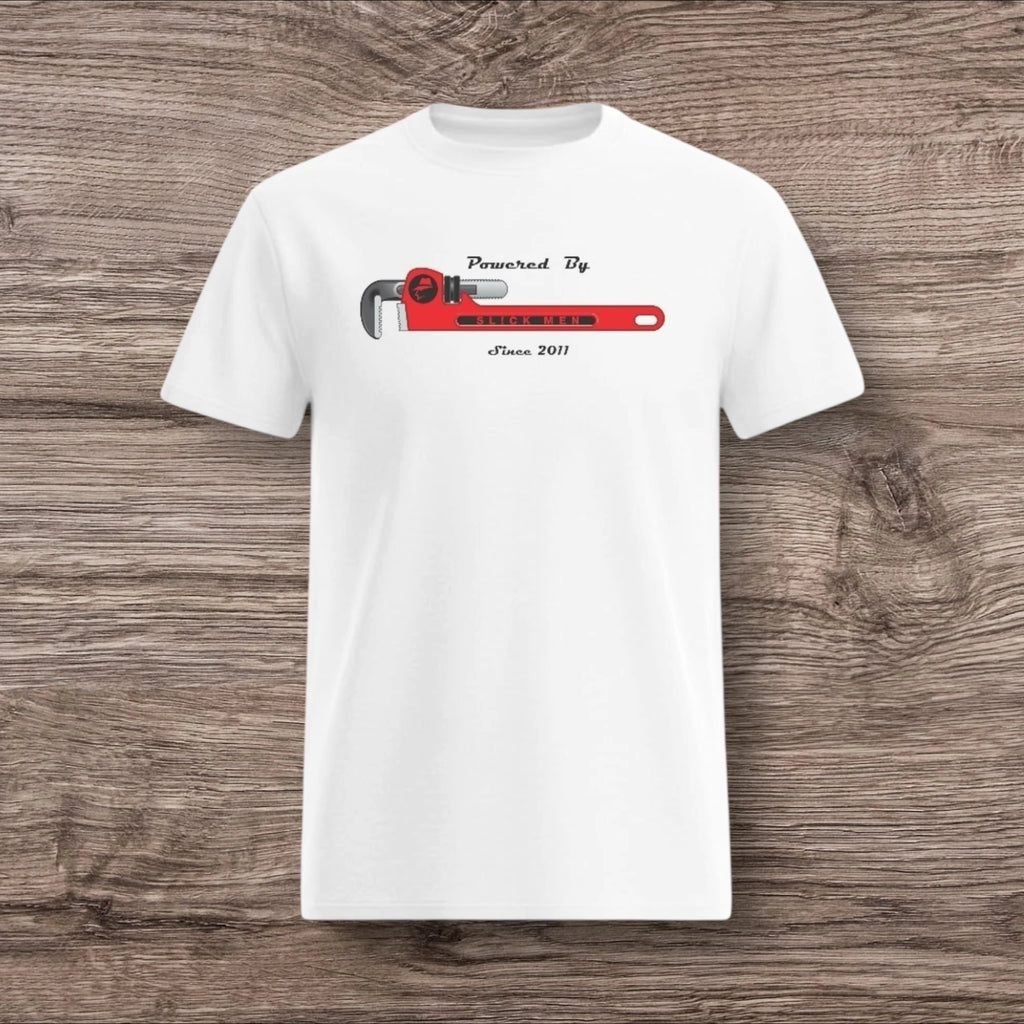 White t-shirt with a plumber wrench design on a wooden surface
