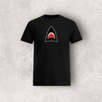 Black t-shirt with a shark graphic on a textured gray background