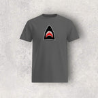 Gray t-shirt with a shark graphic on a textured gray background