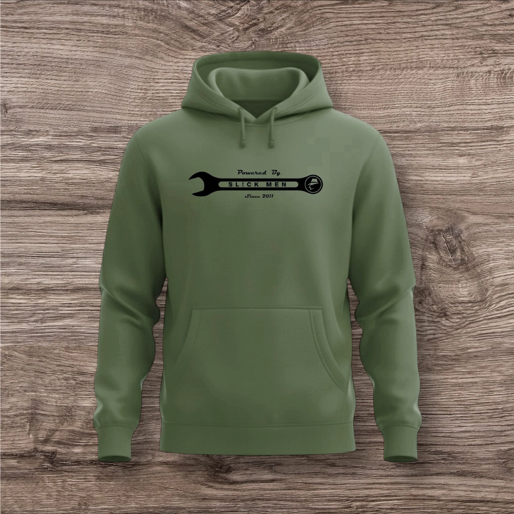 Green hoodie with a black wrench graphic on a wooden surface