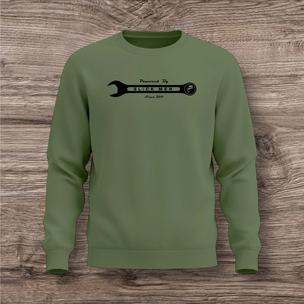 Green sweatshirt with a black wrench graphic on a wooden surface