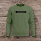 Green sweatshirt with a black wrench graphic on a wooden surface