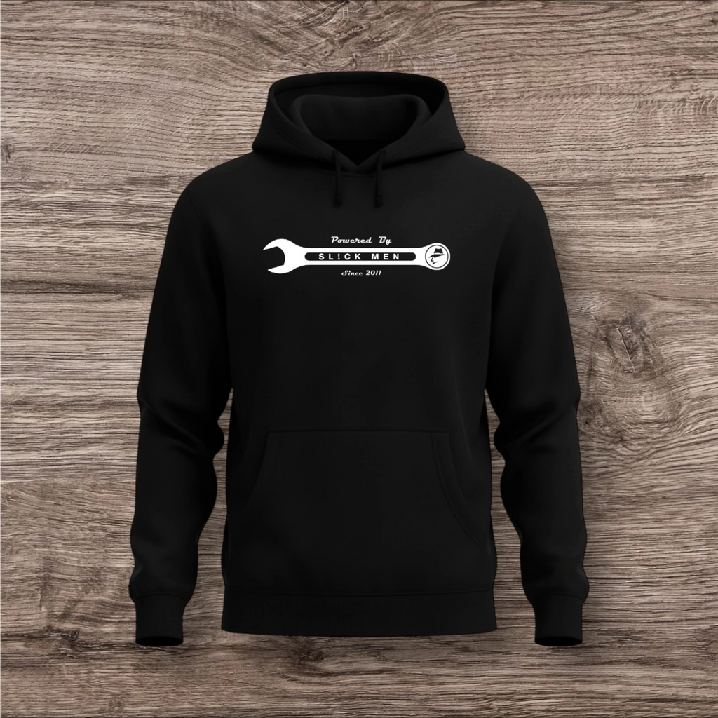 Black hoodie with a white wrench graphic on a wooden surface