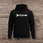 Black hoodie with a white wrench graphic on a wooden surface