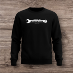 Black sweatshirt with a white wrench graphic on a wooden surface