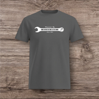 Gray t-shirt with a white wrench graphic on a wooden surface