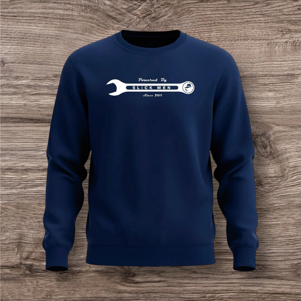Navy blue sweatshirt with a white wrench graphic on a wooden surface