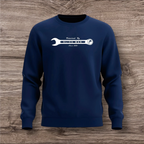 Navy blue sweatshirt with a white wrench graphic on a wooden surface