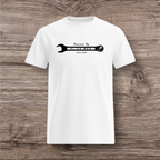 White t-shirt with a black wrench graphic on a wooden surface